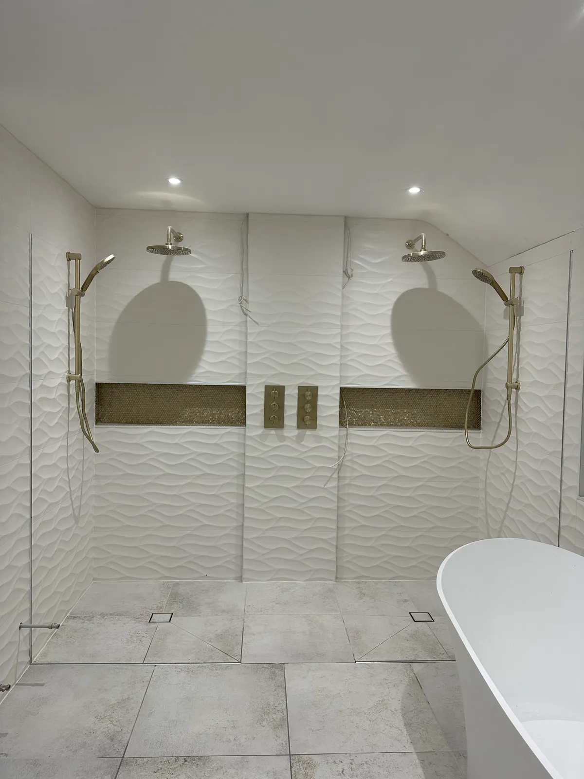 Wet room installation with brass fixtures