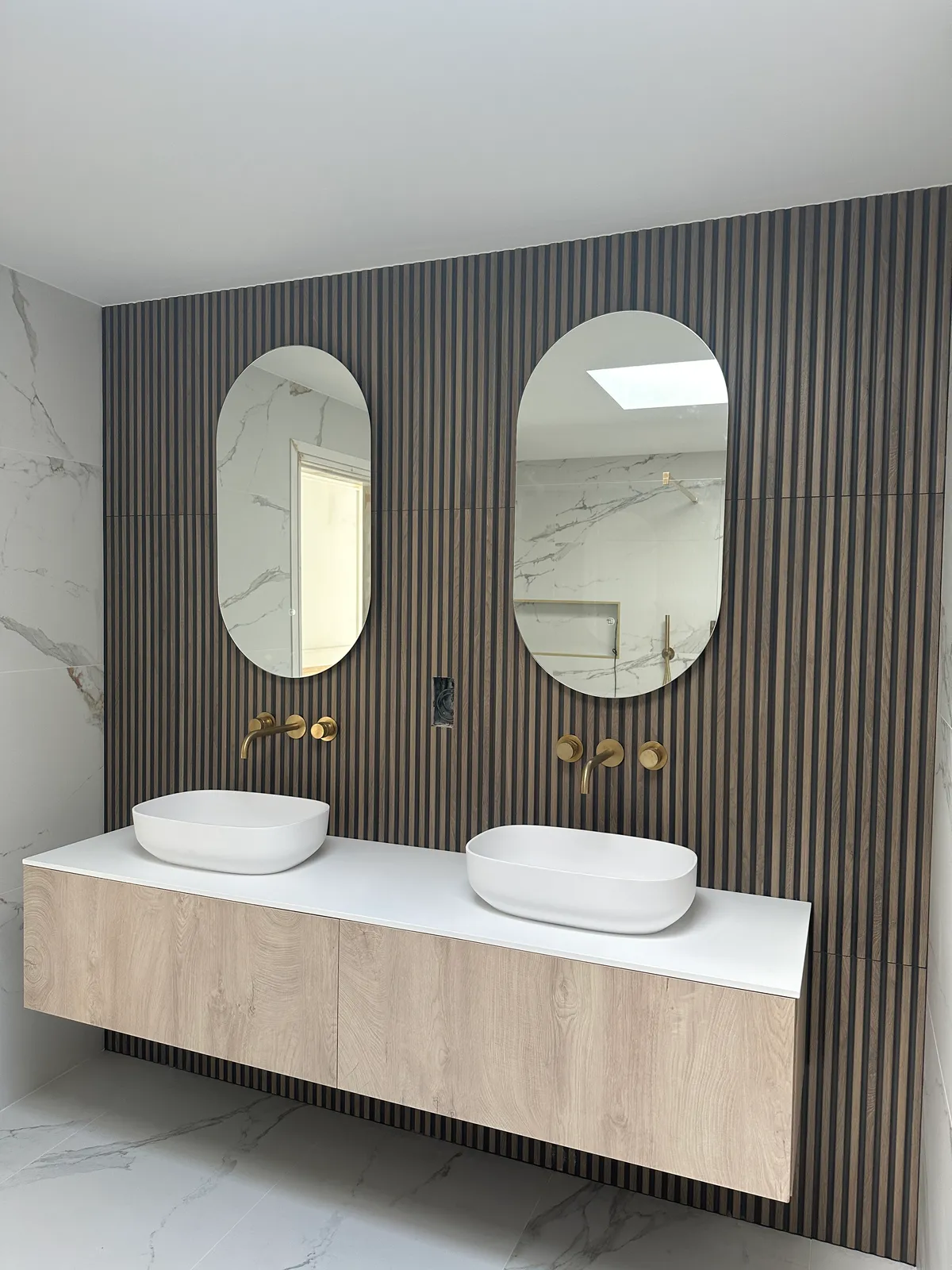 Double vanity unit with cladded timber look porcelain tiles