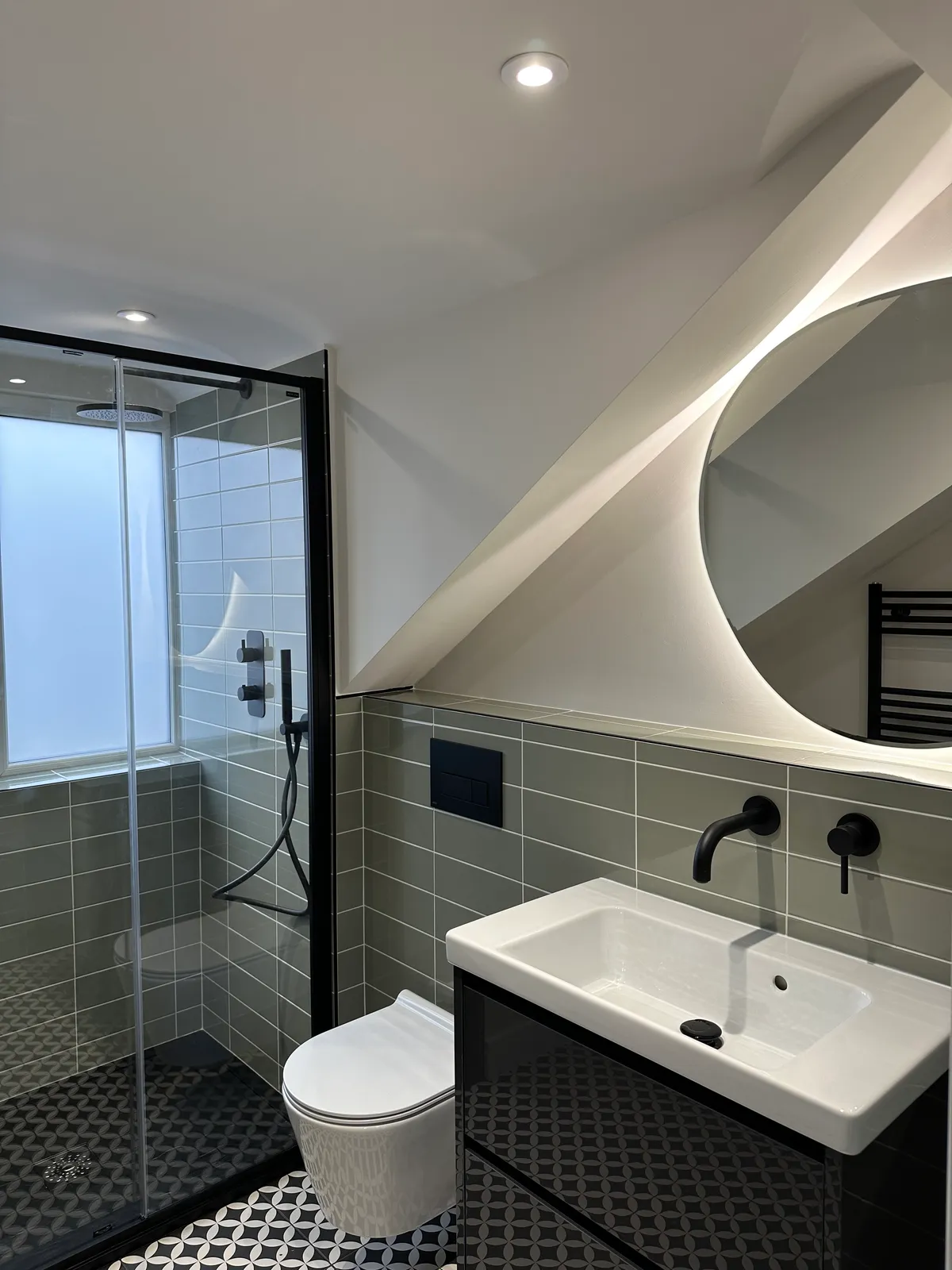 Green metro tiled bathroom with black fixtures