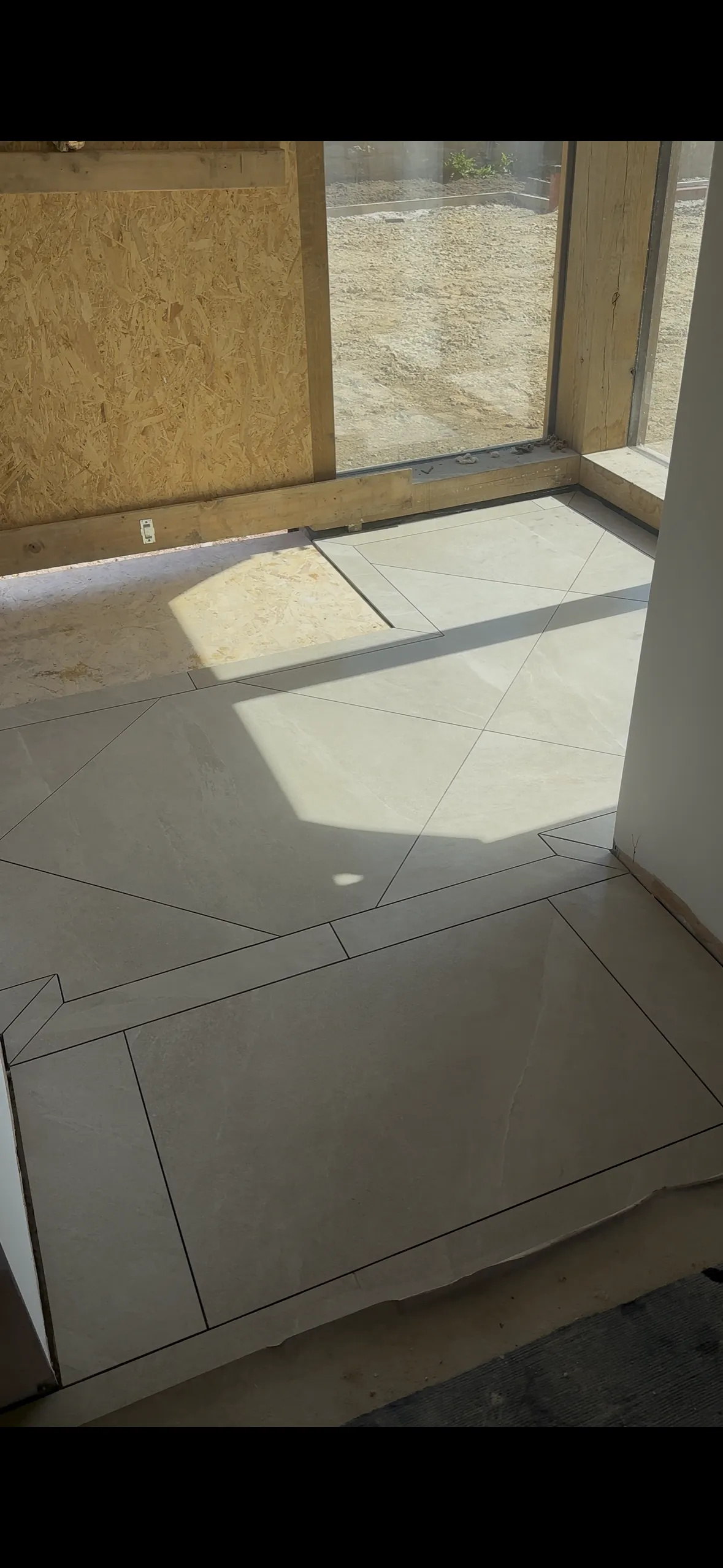Home entrance tiled with border and diagonally placed tiles